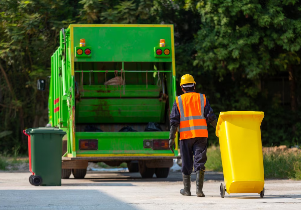 garbage-collector-workers-collect-garbage-with-garbage-collection-truck_61243-1441